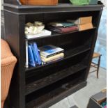 A stained oak open bookcase with galleried top over three adjustable shelves raised on a plinth base