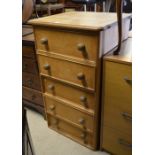 A stained pine tallboy chest of five drawers with turned pulls