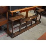 Early 20th century oak club fender with stepped top raised on turned column supports (135cmx39cm
