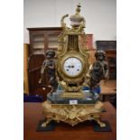 An ornate Italian 'Imperial' gilt metal twin train mantel clock flanked by hoofed putti, c/w with