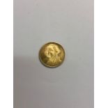 A yellow metal United States of America Bicentennial 1776-1976 coin, 2.4g, 1.7cm diam