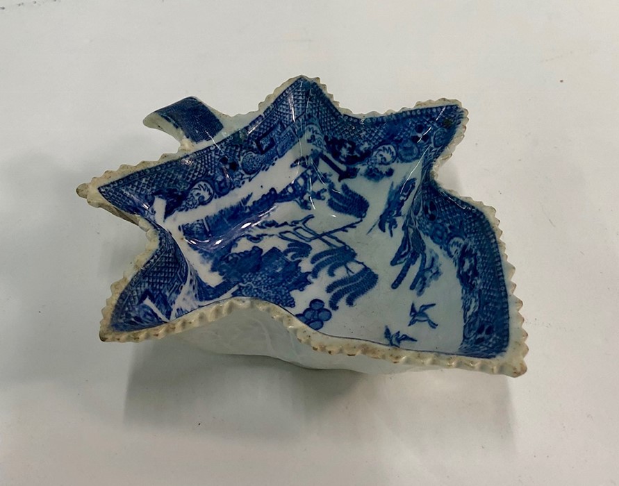 An early 19th century pearlware blue transfer printed willow pattern pickle dish, 13.2 cm longChip