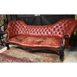 A Victorian rosewood framed button backed red leather sofa, the double spoon back over a