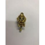 An articulated clown pendant, gilt metal with stone set eyes and enamelled tongue, stamped Monet