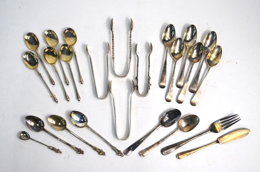 A mixed selection of Georgian and later silver teaspoons and sugar tongs, etc., 10.8 oz total