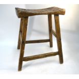An antique 'style' rustic fruitwood joint stool, the dished plank seat on a stock frame, 43 cm w