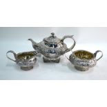 A George IV silver milk and sugar pair in the Regency manner, richly chased and embossed with
