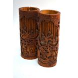 A pair of Chinese bamboo bitongs; each one of typical cylindrical form decorated with scholars in
