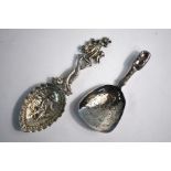 A Continental cast silver caddy spoon with decorative stem and engraved bowl, London import 1905,