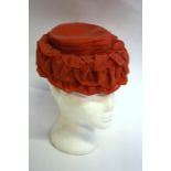 Two 1950s Rayna model hats, 836 Brompton Road SW3 - a coral pink ruched chiffon and net hat, a