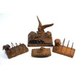 A German Black Forest wood desk set carved with eagles, comprising a pen stand incorporating two ink