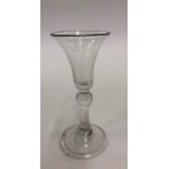 An 18th century cordial glass with bell bowl, inverted baluster stem with basal knop, conical fold