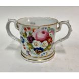 Of Military Interest - A Victorian Staffordshire loving cup,  painted polychrome flowers to one side