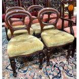 A set of four Victorian mahogany balloon back dining side chairs, with buttoned overstuffed seats,