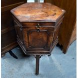 A George III mahogany wine cooler of octagonal form, the hinged top enclosing lead lined