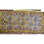 An old Uzbek Julkhyrs rug, circa 1930, the overall tile design in colours, 2.57 x 1.20 m [154]