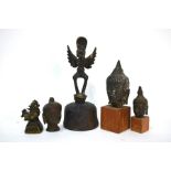 A ghanta with Garuda finial, 16 cm high; together with three small, metal heads of Sakyamuni, and