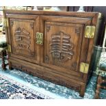 A fine quality Chinese rosewood cabinet, the pair of doors with differing moulded designs over a