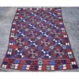 A Uzbek embroidered kilim, circa 1950, the geometric design with red and navy blue bands, 2.49 x 1.