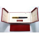 A Cartier Pasha de Cartier, black fountain pen with gilt metal reeded cap, in fitted box -
