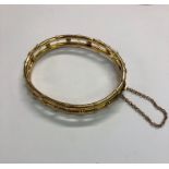 A yellow metal hinged bangle formed of a double row with beads between, concealed snap fitted with
