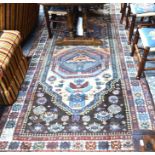 An antique Kurdish Kelleigh carpet, the twin lozenge tablet on camel/brown ground, 3.45 x 1.60 m