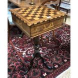 A 19th century Maltese work table, the chequer board top hinged to reveal a fitted tray over a