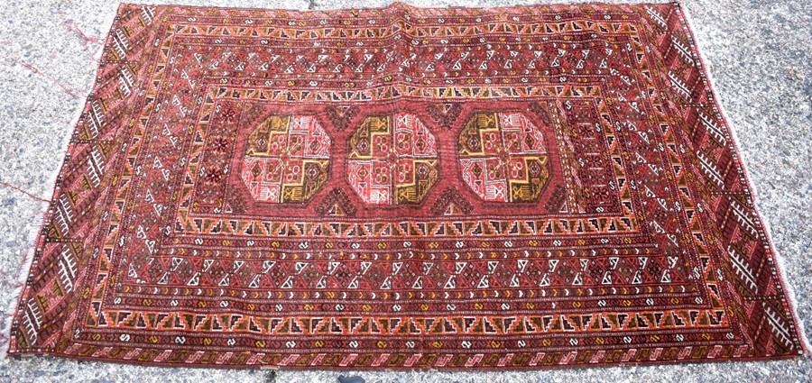 An old Afghan/Uzbek Turkmen rug, circa 1920, the triple gul design on red-brown ground, 195 x 133 cm - Image 7 of 9