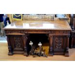 A 19th century Flemish oak pedestal desk, the wide cross-banded top with moulded edge over three