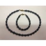 A black pearl and blue bead matching necklace and bracelet set (2)