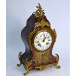 An Edwardian Louis XV style Boulle mantel clock with brass cut inlay, the 8-day two train movement