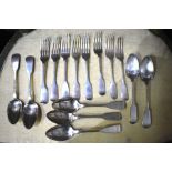 A matched set of seven William IV and Victorian Scottish silver fiddle pattern dessert spoons,