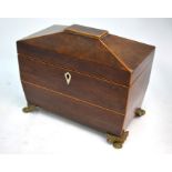 A Regency mahogany sarcophagus tea caddy with two lidded compartments, on ornate gilt brass claw