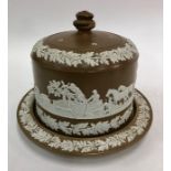 Large brown Jasperware stilton dish and cover decorated with a hunting frieze and borders of
