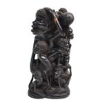 An African Makondo carved wood sculptural group, father with nine children, 24 cm high