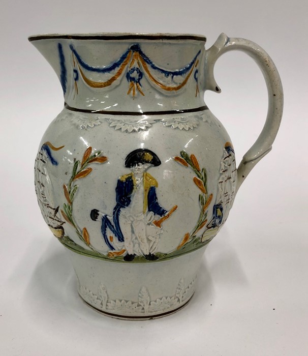 An early 19th century Pratt pearlware jug moulded in relief with images of Nelson and HMS Victory