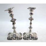 A pair of William IV loaded silver baluster candlesticks in the early 18th century manner, with