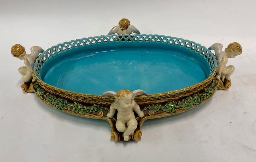 A Victorian Minton Majolica large oval table centrepiece of basket weave form, raised on four
