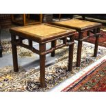 A pair of Chinese rattan panelled hardwood stands or side tables, raised on turned four turned legs,