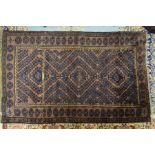 An Afghan Mushwani Baluch rug, circa 1900, the navy radiating diamond with brown ground and