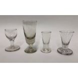 Four Georgian glasses - Dram glass with drawn funnel bowl, two air bubbles, thick flat foot, rough