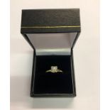 A single stone diamond ring, the circular brilliant cut diamond in square mount, yellow and white