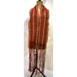 A vintage hand-crafted red wool scarf with long fringe and beaded dart pattern, an ivory silk