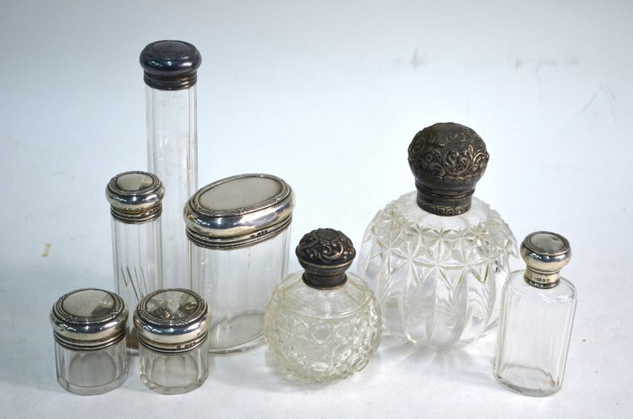 Eight silver-topped cut glass toilet bottles and jars, W & G Neal, London 1910