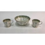 An early 19th century English porcelain bowl of spiral wrythen form and two matching coffee cups