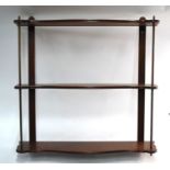 A pair of mahogany and brass three-tier wall-shelves with acorn finials, 66 cm wide