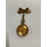 A lady's 14k fob watch with engraved case and gilt dial, top-wind English movement with steel dust-