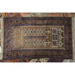 An old Afghan Timuri Baluch prayer rug, the triple mihrab design on gold-brown ground, circa 1920