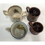Three Victorian tankards with frogs to the interiors - Tankard moulded with seated drinkers, 12 cm
