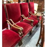 A companion set of five moulded and carved walnut framed armchairs, four upholstered in burgundy